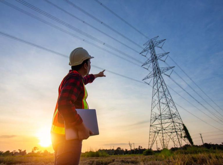 worker pointing to power lines