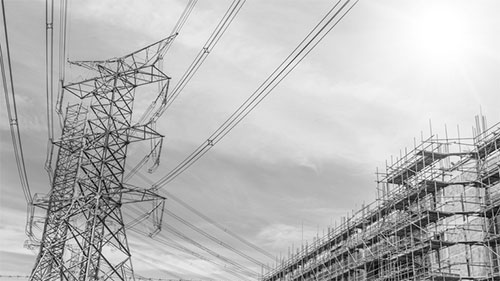black and white image of power lines and building