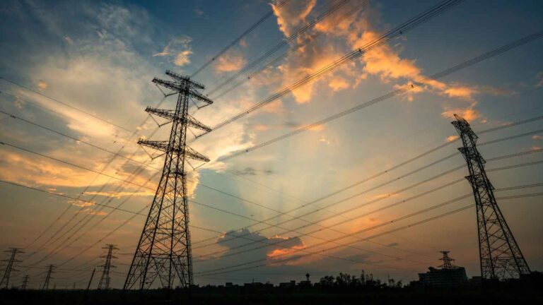 criss-crossing power lines against sunrise