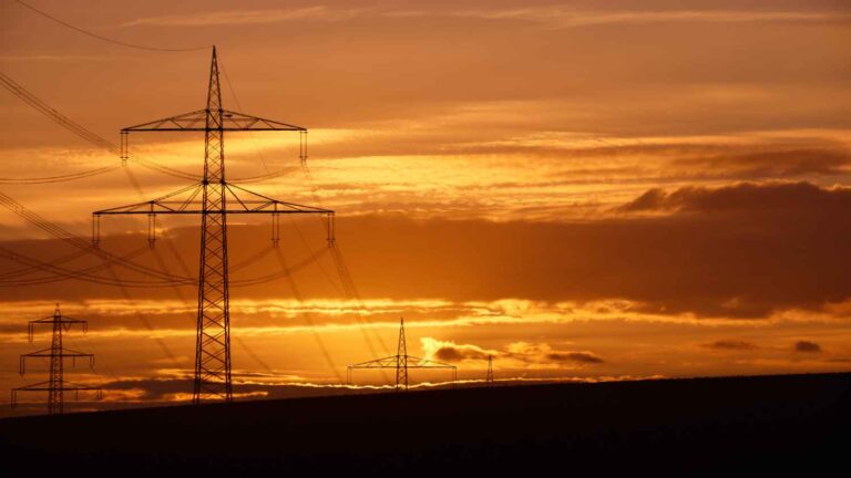 power lines against orange sky