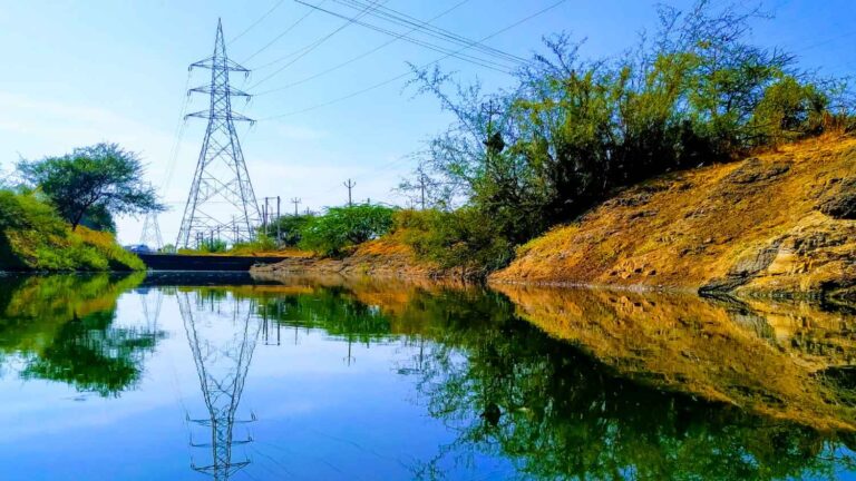 power line tower next to water