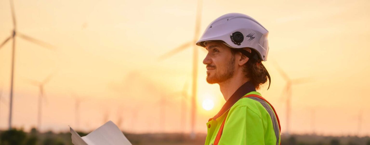 worker in hard hat holding papers